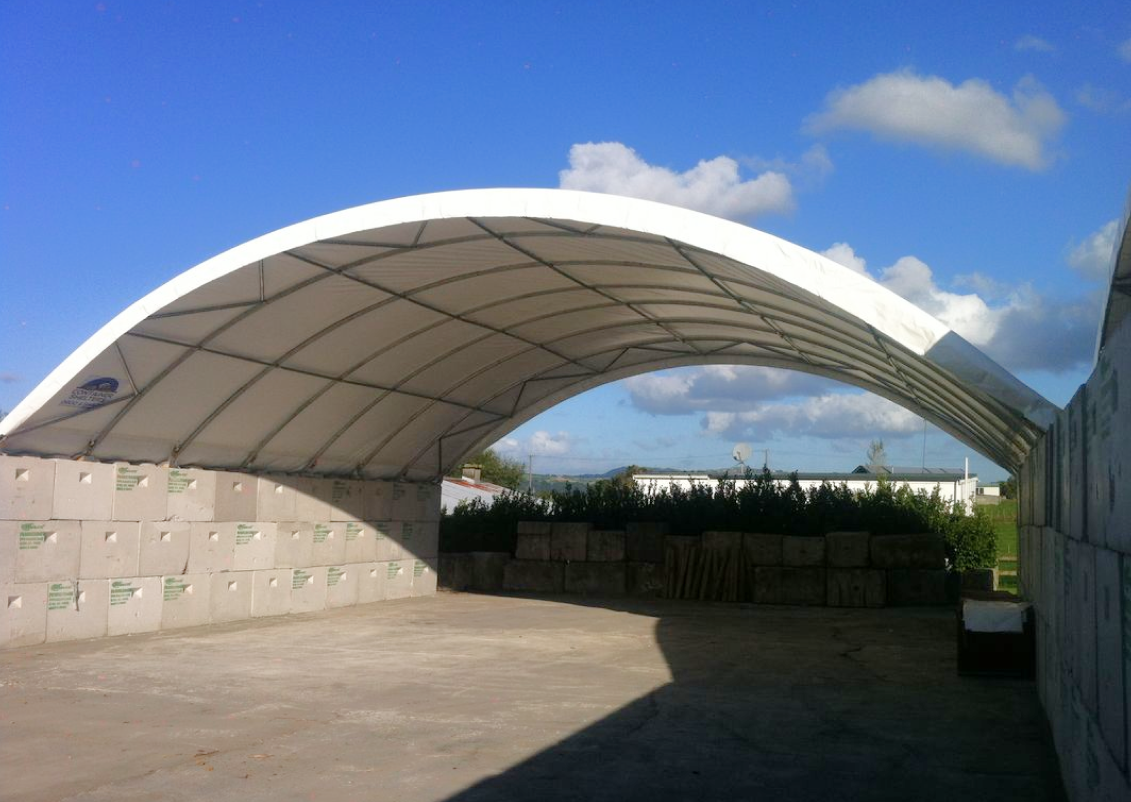 Block mounted container shelter over bulk storage
