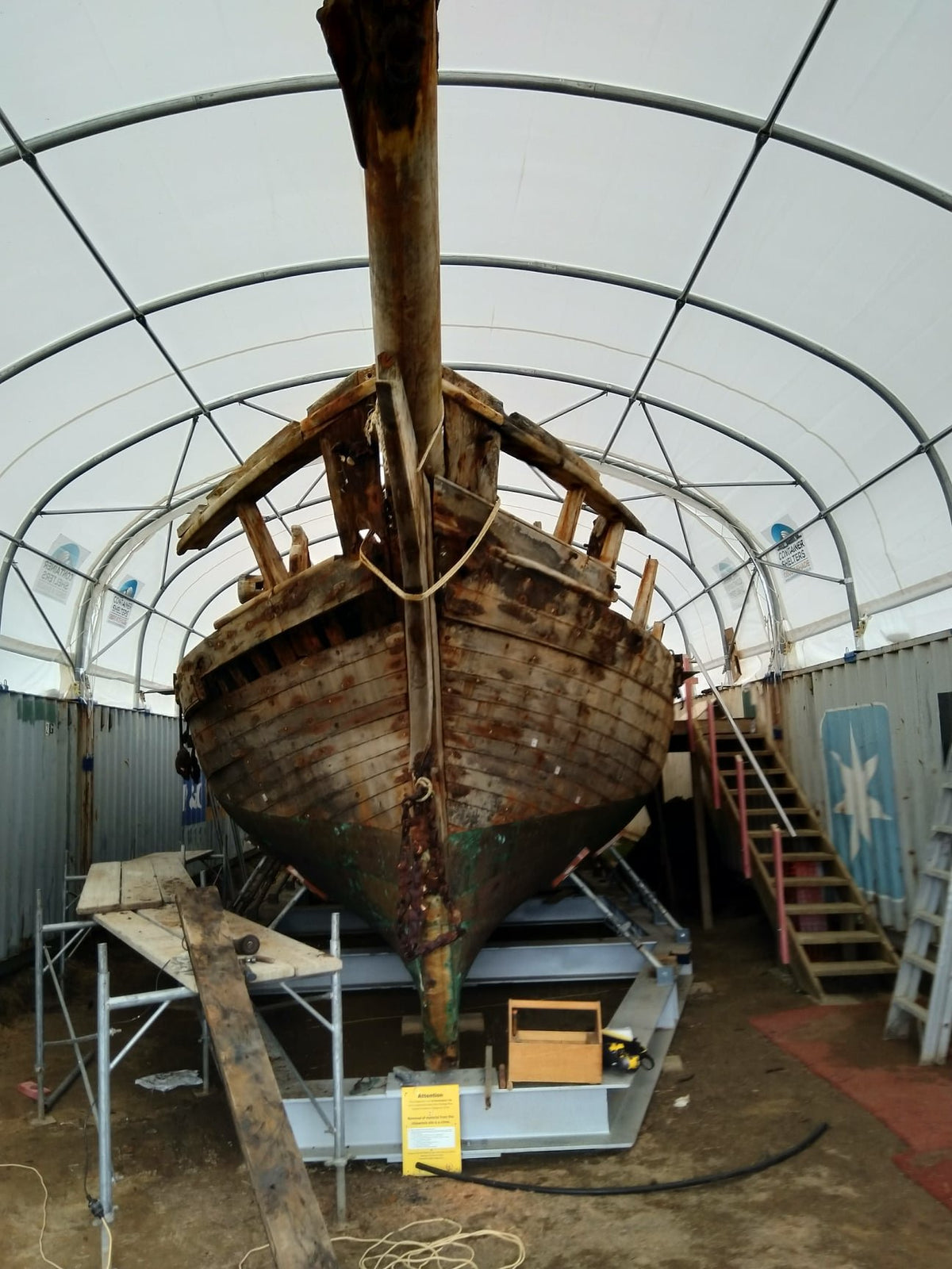 Container shelter covering a historic vessel at Mangawhai Museum